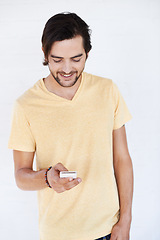 Image showing Phone, communication and man on technology typing a cellphone text with isolated white background. Mobile conversation, model and smile of a person with a mobile phone texting with technology