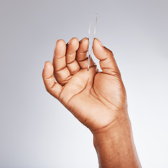 Image showing Beauty, grooming and hand of man with tweezers for skincare, body dermatology and eyebrows on a grey studio background. Health, hygiene and model with a cosmetic tool for hair plucking and wellness