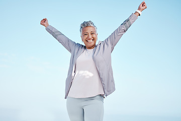 Image showing Excited senior woman with hands in air for exercise, fitness or workout portrait goals, success and achievement on blue sky mockup. Winner, freedom and healthy celebration of elderly runner in nature