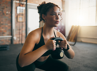 Image showing Exercise, kettlebell and a woman at gym breathing during workout, exercise and weight training for body wellness. Strong sports female or athlete with weights for power, muscle and healthy lifestyle