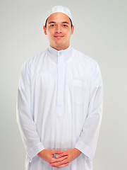 Image showing Portrait, muslim and faith with an islamic man in studio on a gray background for religion, belief in god or devotion. Eid, worship and ramadan with a male arab fasting in holy tradition or culture