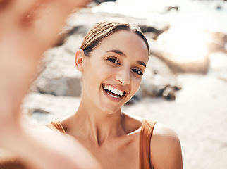 Image showing Selfie, beach and travel with a woman tourist taking a picture outdoor during summer vacation or holiday. Portrait, face and smile with an attractive young female happy on the coast by the sea