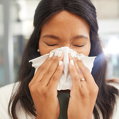 Image showing Woman, sneeze and tissue for flu, covid and safety in workplace with hands on face for health by blurred background. Corporate black woman, office and sick with toilet paper, nose and covid 19 virus