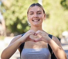 Image showing Portrait, woman and heart shape in nature while outdoor for freedom, love and support for summer travel adventure. Happy young female with hand sign and backpack for motivation, peace and wellness