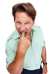 Image showing Portrait, gross and nausea with a man model in studio isolated on a white background feeling ill or sick. Face, finger and mouth with a male standing on blank space in disgust or expressing turn off