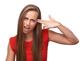 Image showing Woman, studio portrait and gun hand to head with anger, crazy and annoyed by white background. Isolated model, comic and weapon sign to temple with mad face, mental health and clothes for fashion