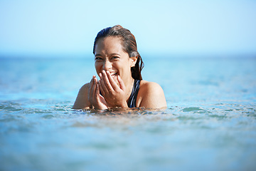 Image showing Young woman swimming in ocean, happy on beach vacation and freedom of summer adventure in Mauritius. Female tourist laughing in the water, tropical destination for travel and natural outdoor paradise