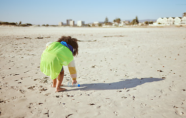 Image showing Plastic bottle, beach and child recycling for ocean, earth day or climate change education, learning and volunteer support in nonprofit. Girl recycle, environment and bottle on ground for pollution