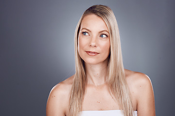 Image showing Hair, beauty and thinking with a model woman in studio on a gray background for a haircare treatment idea. Wellness, health and keratin with an attractive young female posing to promote natural care