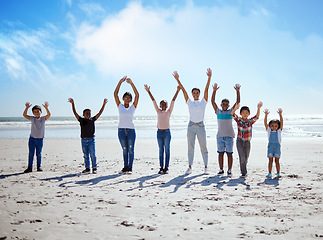 Image showing Children, beach and friends in summer with their arms raised while standing on the sand by the sea or ocean. Portrait, kids and gesture with a boy and girl friend group by the coastal water