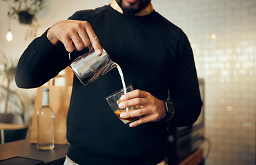 Image showing Coffee, milk and hands of man in cafe for cappuccino, breakfast and caffeine beverage. Relax, espresso and dairy with barista in coffee shop and with latte for retail, mocha and drink preparation