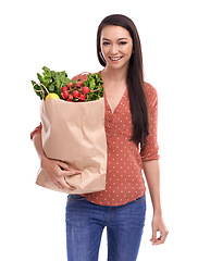 Image showing Woman, happy portrait and healthy food or grocery shopping bag in white background for nutrition health, vegetables diet and happiness isolated in studio. Model, face and smile for organic groceries