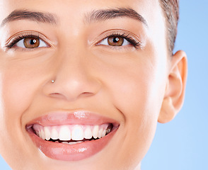 Image showing Teeth, dental and face portrait of woman with clean smile, teeth whitening and oral self care on blue background. Tooth implant, healthcare and beauty model with makeup, cosmetics and facial skincare