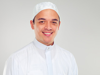 Image showing Portrait, muslim and religion with an islamic man in studio on a gray background for faith, belief in god or devotion. Eid, worship and ramadan with a male arab fasting in holy tradition or culture