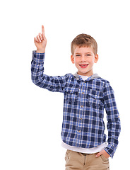 Image showing Kid, portrait and hand pointing to idea space with optimistic, friendly and happy smile for advertising. Happiness, cute and young child presenting mock up for marketing on isolated white background.