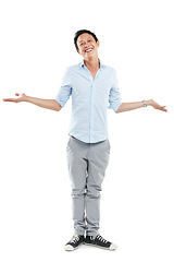 Image showing Man, happy portrait and shrugging in studio with a smile and open or empty hands isolated on white background. Asian male model advertising a positive mindset, happiness and lifestyle balance