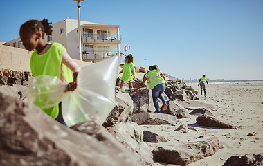 Image showing Beach cleaning, plastic and children volunteer for education, learning and community help in climate change project, ngo and charity. Friends or students with waste, garbage or trash for earth day