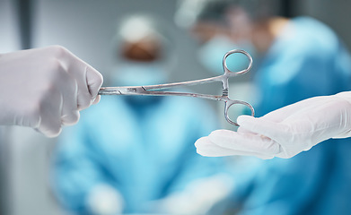 Image showing Hospital, surgery and doctor giving scissors in hands for theatre teamwork, medical trust and support with healthcare insurance background. Metal tools, surgeon and nurse helping in an operating room