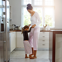Image showing Dance, love and mother with girl in kitchen play, fun and bonding, happy and relax in their home. Mom, daughter and dancing in their house, morning and playing while enjoying free day on the weekend
