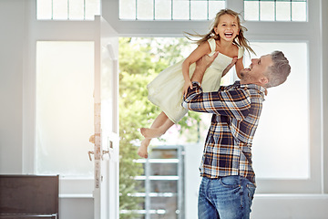 Image showing Happy, love and father carrying a girl in their modern family home for fun, care and happiness. Smile, bonding and mature man playing with his excited child daughter in their house in Australia.