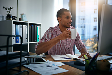 Image showing African businessman, coffee and reading at computer, office and planning with vision, goal and start morning. Corporate black man, pc and notebook for strategy, mission and email for communication