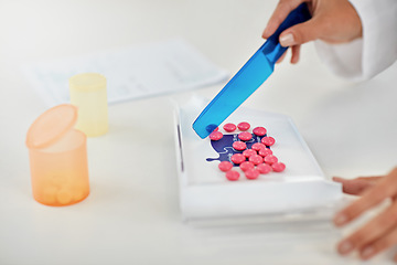 Image showing Hands, pharmacist and counting pills for prescription, packaging or inventory at a pharmacy. Hand of doctor working with medication tablets or pharmaceutical drugs for healthcare on counter at clinic