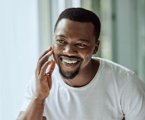 Image showing Face, antiaging and skin with a black man looking in the bathroom mirror during his morning routine at home. Skincare, beauty and reflection with a handsome male grooming for wellness or natural care