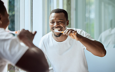 Image showing Morning, happy and black man brushing teeth in bathroom for health, hygiene and clean smile. Self care, cleaning and oral hygiene for healthy teeth of person smiling with confidence in home.