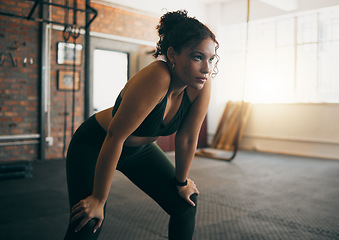 Image showing Fitness, exercise and woman tired at gym after a workout or training for health and body wellness. Young sports female or athlete resting on break while thinking about goals, progress and performance