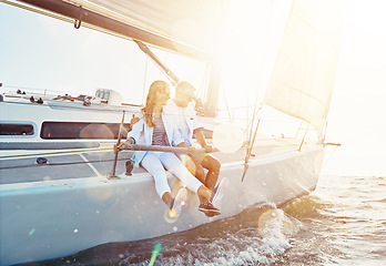 Image showing Couple, relax boat trip and ocean sunset for travel holiday, summer vacation or romantic quality time. Luxury yacht cruise, man and woman bonding and happy sailing together for sea love adventure