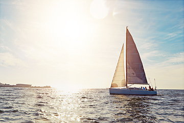 Image showing Mockup, sunset and a yacht at sea for travel, tourism or a luxury summer vacation outdoor. Blue sky, water and wave with a boat on the ocean in nature for an adventure, holiday or getaway with flare