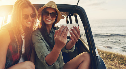 Image showing Friends, smile and road trip phone selfie with sunset for travel holiday, summer vacation and relax together outdoor. Women, happy and smartphone photography for adventure or countryside sunshine