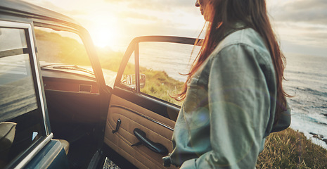 Image showing Vintage car, sunset and woman by ocean for road trip, travel and summer vacation for journey, adventure and freedom. Young, gen z driver by sea, ocean or lake for retro lifestyle with transportation