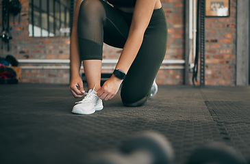 Image showing Woman, tie shoes and gym fitness exercise for sports wellness, training workout and runner cardio lifestyle. Athlete legs, checking sneakers lace and start running motivation for body health goals