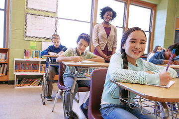 Image showing Education, exam and portrait of a girl in class to study, writing and test at school. Happy, learning and student with a smile for studying in a classroom, notes and knowledge from a teacher