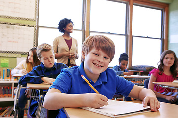 Image showing Smile, education portrait or kid in classroom writing in notebook for learning, research or study for exam. Scholarship, thinking or students happy in school with book for test, academy or assessment