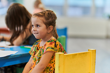 Image showing Creative kids sitting in a preschool institution, draw and have fun while they get an education