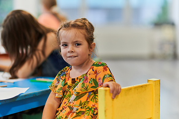 Image showing Creative kids sitting in a preschool institution, draw and have fun while they get an education