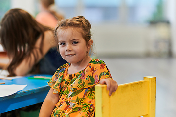 Image showing Creative kids sitting in a preschool institution, draw and have fun while they get an education