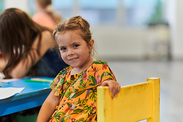 Image showing Creative kids sitting in a preschool institution, draw and have fun while they get an education