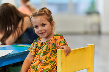 Image showing Creative kids sitting in a preschool institution, draw and have fun while they get an education