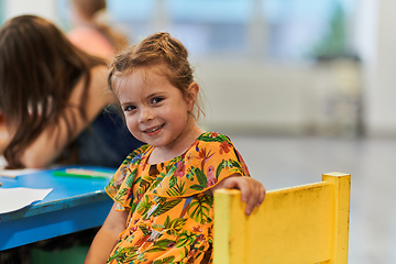 Image showing Creative kids sitting in a preschool institution, draw and have fun while they get an education