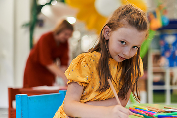 Image showing Creative kids sitting in a preschool institution, draw and have fun while they get an education