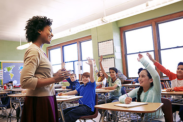 Image showing School, teacher and children raise their hands to ask or answer an academic question for learning. Diversity, education and primary school kids speaking to their woman educator in the classroom.