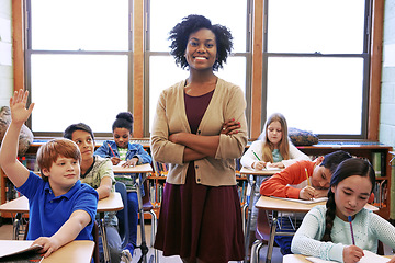 Image showing Portrait, student question and black woman teacher in classroom or middle school. Education, arms crossed or boy raising hand to answer questions, studying or learning help with happy female educator