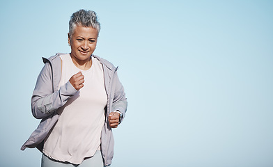 Image showing Senior woman, fitness running and blue sky outdoor exercise for retirement sports wellness, health workout and cardio training. Elderly athlete, focus and runner freedom and marathon lifestyle