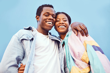 Image showing Couple, love or bonding hug by city wall background in trust, security or support in relax urban date, fun activity or holiday. Portrait, happy smile or black woman and man embrace on building mockup