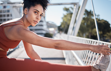 Image showing Stretching legs, sports and woman on bridge for exercise, running workout or training in sports motivation, focus and thinking. Warm up, goals and urban athlete in city for pilates, muscle and health