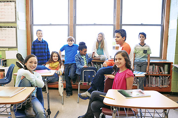 Image showing Children, school and portrait in a classroom while together to learn for study for knowledge and education. Boy and girl group students in class while learning for future development with friends