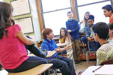 Image showing School, children and talking about education in a classroom to learn, study and share knowledge. Boy and girl group discussion with students in class learning for future, development and growth